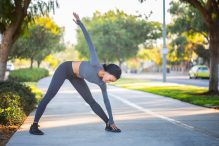 woman stretching after her running warm up