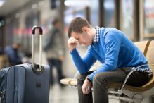 young man tired at airport terminal