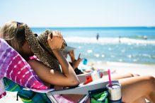 woman sleeping in beach chair at the beach