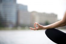 hand resting on knee in meditation pose